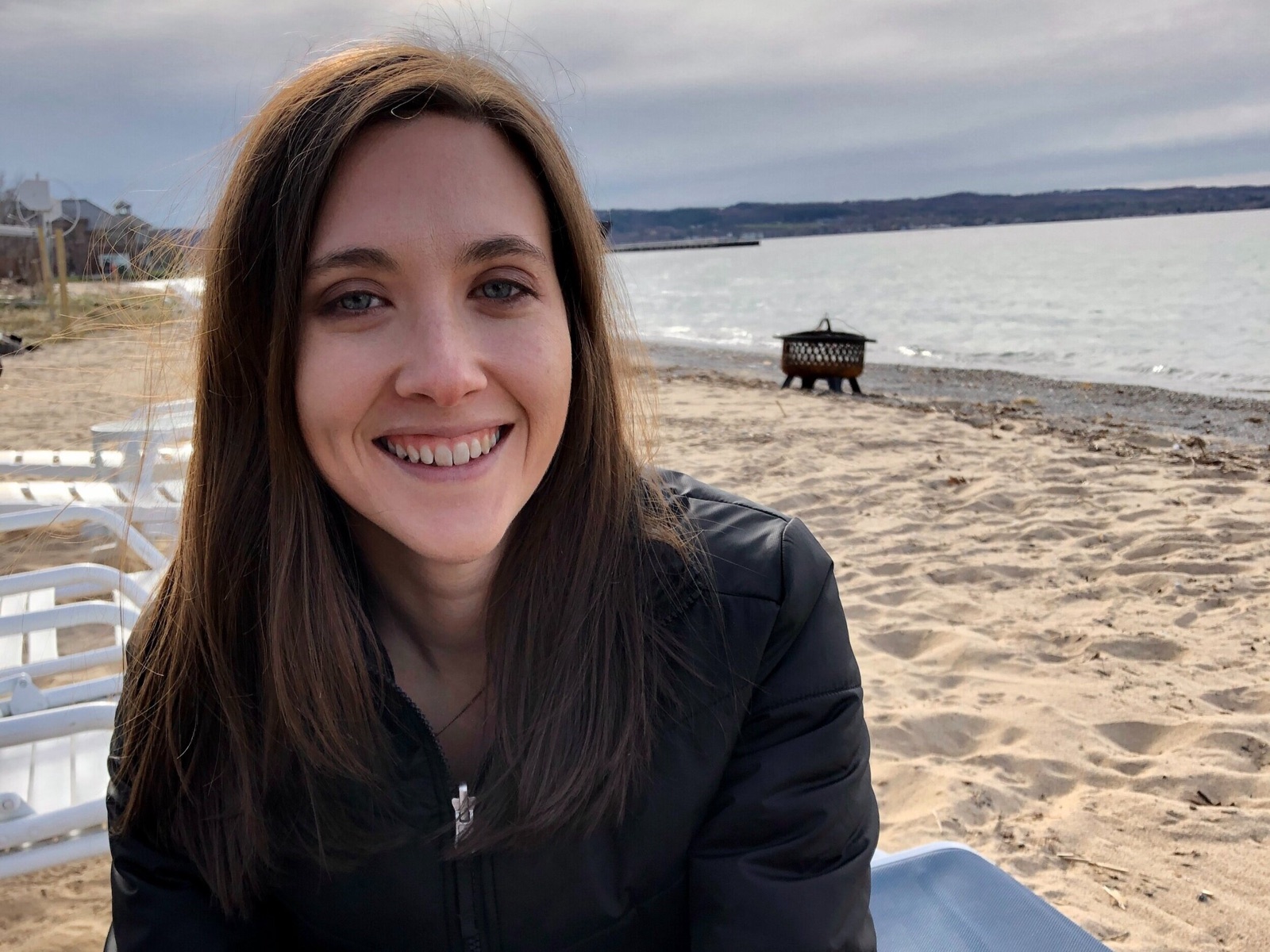 Stephanie Hall smiling on a Lake Michigan beach